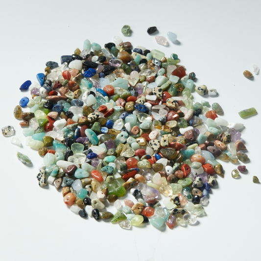 Close-up of assorted natural gemstone chip beads, multicolor polished with drilled holes