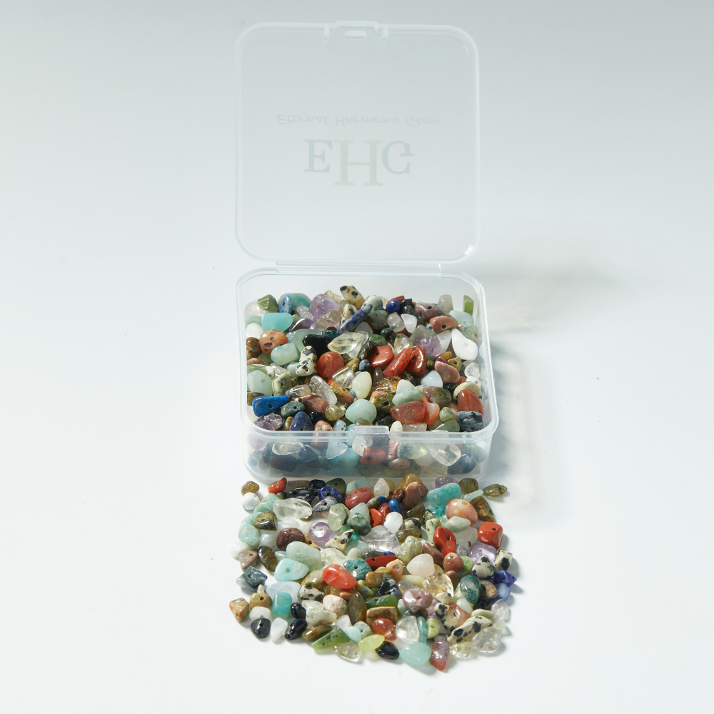 Close-up of assorted natural gemstone chip beads, multicolor polished with drilled holes