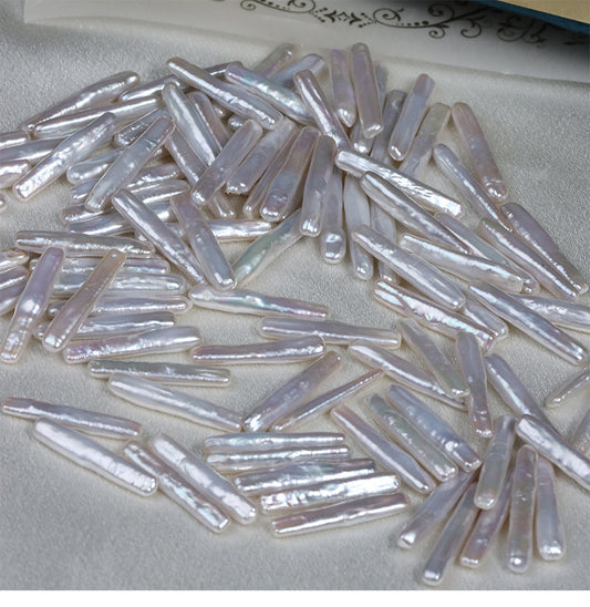 Close-up of baroque stick pearls in hand, showing unique surface textures