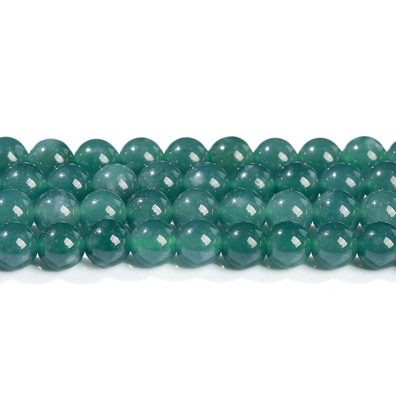 Green jadeite round beads reflecting light, showcasing high clarity.