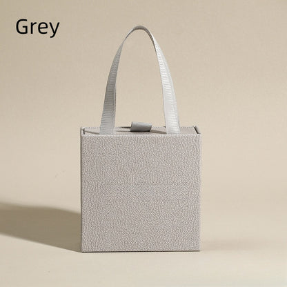 Grey jewelry drawer box with white ribbon handle