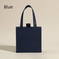 Blue textured jewelry box with navy ribbon handle