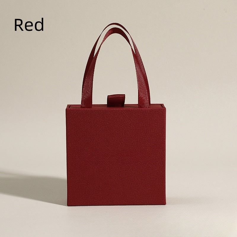 Red jewelry box with elegant design and handle