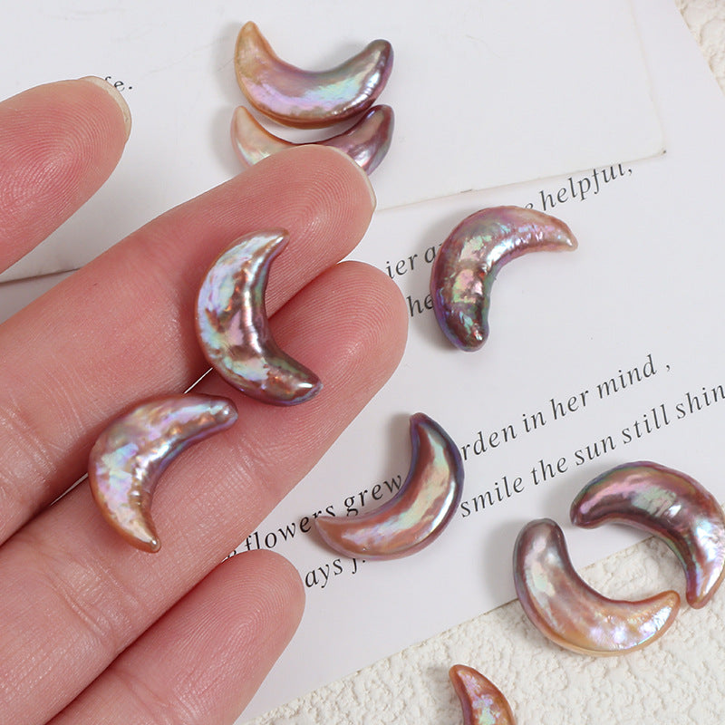 Hand holding iridescent baroque moon-shaped freshwater pearls