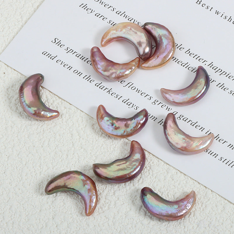 Close-up of colorful moon-shaped pearls on white paper