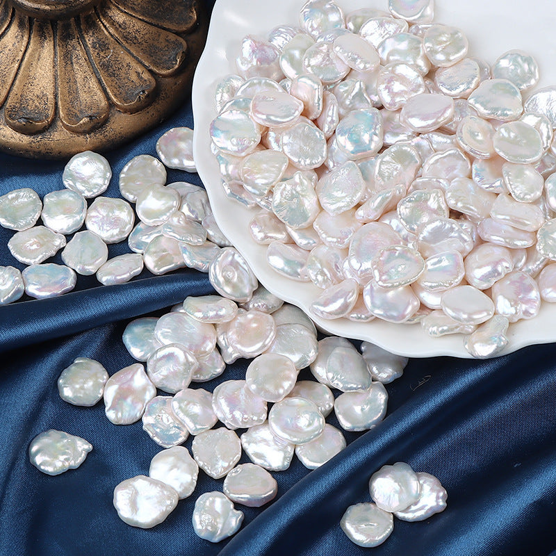 A white dish filled with shiny petal pearls for jewelry making