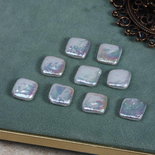 Freshwater baroque square pearls arranged on a green velvet board